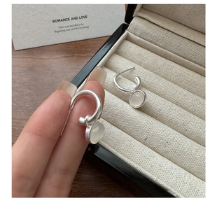 Close-up of S925 silver hoop earrings with translucent chalcedony stone pendants