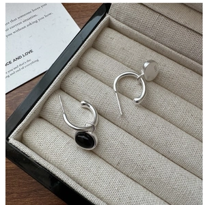 Detailed macro view of S925 sterling silver stamp on black agate drop earrings