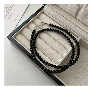Macro detail of S925 sterling silver clasp on a black onyx beaded necklace with S925 hallmark