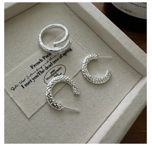 Detail of S925 sterling silver hammered texture ring and matching C-shape earrings