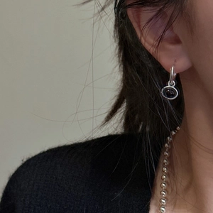 S925 sterling silver drop earrings featuring black chalcedony on a minimalist model close-up