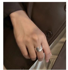 Close-up of S925 sterling silver irregular wave ring on hand with modern matte finish