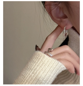 Close-up of S925 sterling silver ring and hoop earring set with hammered texture design