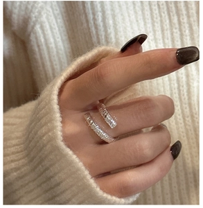 Detailed view of S925 sterling silver cross ring with hammer textured finish on knit