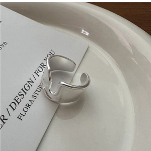 Macro shot of S925 sterling silver wide ring featuring matte brushed texture and wavy edges