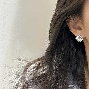 Minimalist S925 sterling silver square huggie hoop earrings worn by a model