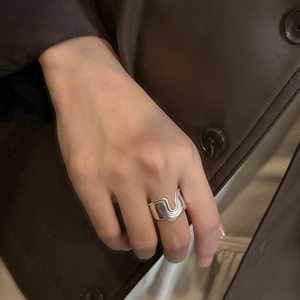 Minimalist S925 sterling silver wide wave ring with irregular textured design on model hand