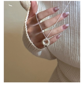 Detail of 925 sterling silver double ring pendant on minimalist box chain necklace
