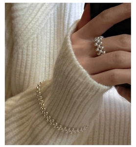 Detail view of handmade 925 sterling silver beaded ring and bracelet on hand