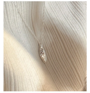 Close-up of S925 sterling silver necklace featuring an irregular textured bar pendant