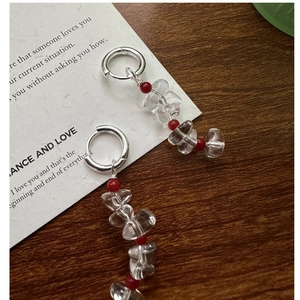 Detail of S925 sterling silver earring with white crystal beads and red accent