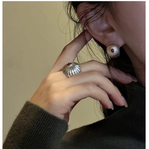 Close-up of S925 sterling silver earrings with red agate and vintage pleated texture