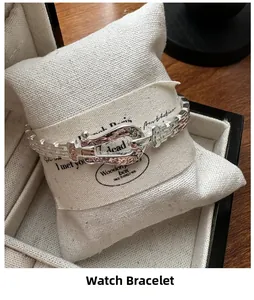 Macro shot of silver strap-style bracelet with horseshoe buckle on jewelry pillow
