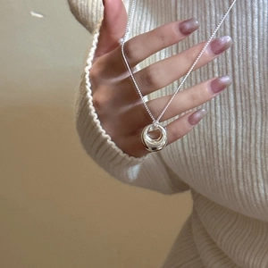 Minimalist 925 sterling silver nested rings pendant necklace on knitted sweater