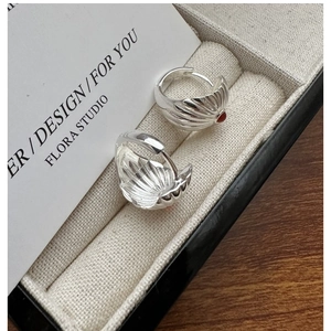 Detailed view of S925 sterling silver shell texture hoop earrings with red agate beads