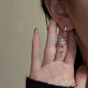 S925 silver drop earrings with red and clear crystal beads on a model's ear