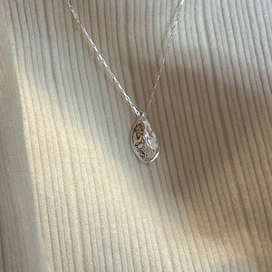 S925 sterling silver water ripple teardrop pendant necklace on beige knit fabric