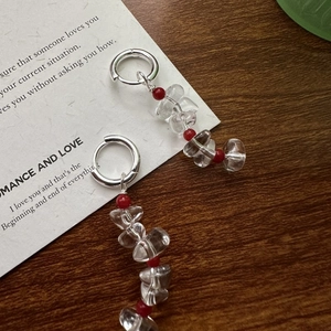 S925 sterling silver drop earrings with white crystal beads on a vintage paper background