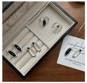 Detailed view of S925 sterling silver jewelry set with oval onyx stones in black and white