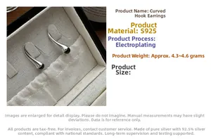 Macro detail of S925 sterling silver hook earrings with black beads on a linen box