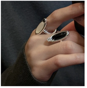 Minimalist S925 sterling silver rings set with white and black chalcedony on a hand