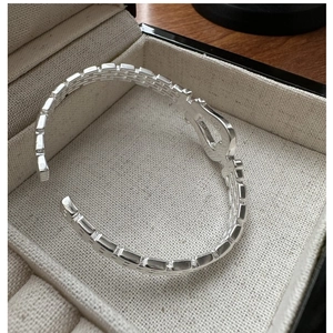 Detail shot of S925 sterling silver cuff bracelet with grid texture in jewelry box