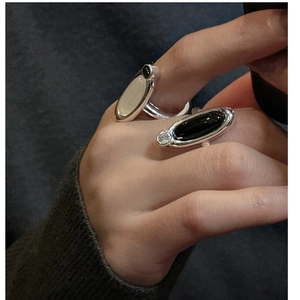 Detail of silver S925 rings featuring oval chalcedony and agate stones on hand
