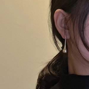 Elegant S925 sterling silver waterdrop earrings on model with high-polish mirror finish