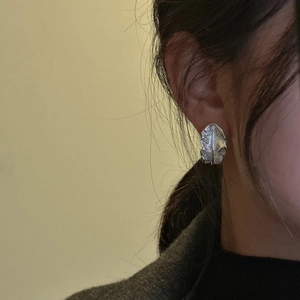 S925 sterling silver feather leaf earrings worn by model with detailed leaf texture