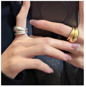 Close-up of minimalist S925 sterling silver dome rings in gold and matte silver finish