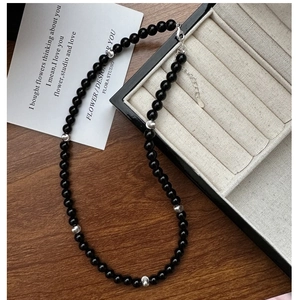 Detail of black onyx beaded bracelet with silver spacers and adjustable lobster clasp