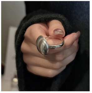 Detail showing the S925 sterling silver hallmark on the polished minimalist round ring