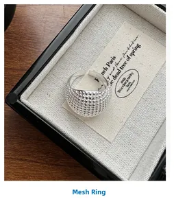 Macro detail of S925 sterling silver ring with textured grid pattern and S925 stamp