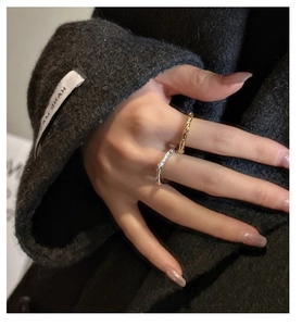 Macro shot of gold and silver textured rings with hand-made hammered finish on fingers
