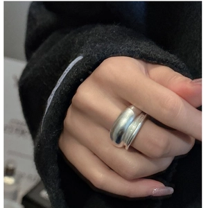 Detailed view of a thick double-layered matte silver ring with wrap-around design