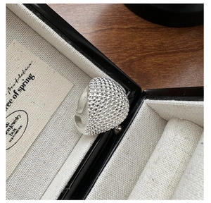 Macro shot of S925 sterling silver adjustable ring with textured bead and logo engraving
