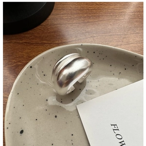 Macro detail of a double-layered S925 sterling silver ring with a soft satin matte finish