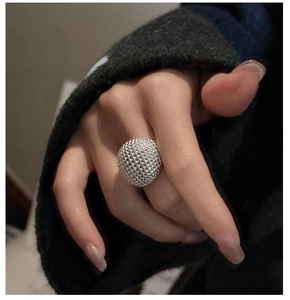 Close-up of S925 sterling silver ring with large textured dome and beaded finish