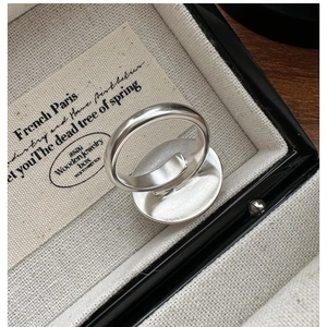 Macro view of a matte S925 silver adjustable ring with a flat round base in a jewelry box