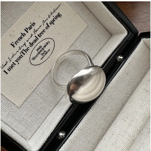 Close-up of matte S925 sterling silver ring with internal hallmark in a jewelry box