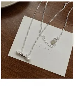 Detailed shot of S925 sterling silver stamp and freshwater pearl balance bar pendant