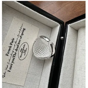 Macro detail of S925 sterling silver ring with grid texture on a jewelry box display