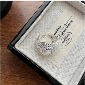 Close-up of S925 sterling silver beaded ring with vintage texture in a jewelry box
