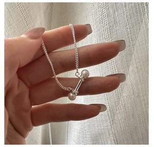 Close-up of S925 silver necklace with unique freshwater pearl balance bar pendant