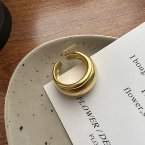 Minimalist double layer matte gold S925 sterling silver ring on a ceramic plate