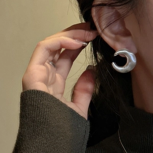 Polished S925 sterling silver crescent moon hoop earrings on model for a trendy look