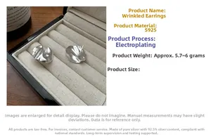 Detailed close-up of S925 sterling silver crumpled stud earrings on a velvet jewelry box
