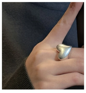 Macro shot of minimalist S925 sterling silver ring featuring a 3D matte heart design