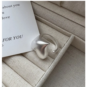 Detailed view of matte S925 sterling silver irregular heart ring on a soft fabric display