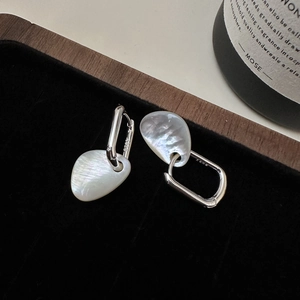 Irregular white mother-of-pearl earrings with S925 silver rectangular hoops on black velvet